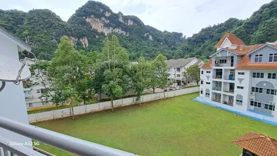 a balcony with a large yard with trees and mountains at Husinza Two LWOT in Ipoh