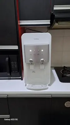 a white coffee maker on a counter next to a microwave at Husinza Two LWOT in Ipoh