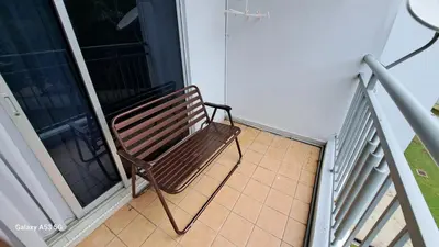 a bench sitting on a balcony next to a window at Husinza Two LWOT in Ipoh