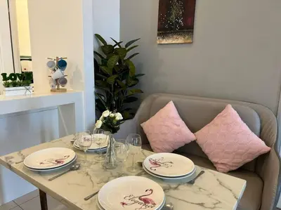 a table with plates and wine glasses on it at Sea Breeze Haven 2BR Seaview w Bathtub 海风乐园海景套房 by Minsù in Tanjong Tokong