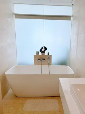 a white bath tub in a bathroom with a window at Sea Breeze Haven 2BR Seaview w Bathtub 海风乐园海景套房 by Minsù in Tanjong Tokong
