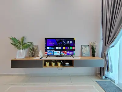 a desk with a computer on it in a room at Ipoh Meru 3 Bedroom Suites by IWH Suites in Ipoh