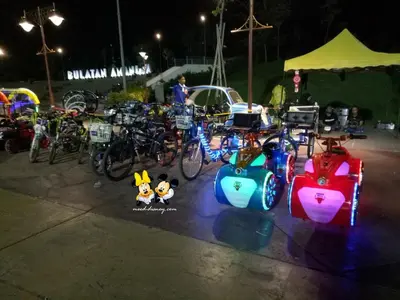 a group of bikes parked in a parking lot at night at Ipoh Meru 3 Bedroom Suites by IWH Suites in Ipoh