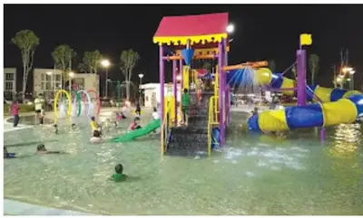 a group of people playing in a water park at night at Ipoh Meru 3 Bedroom Suites by IWH Suites in Ipoh