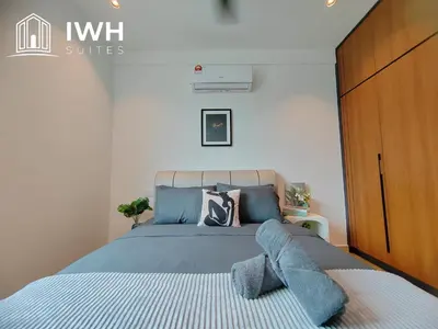 a bedroom with a blue bed with a wooden cabinet at Ipoh Meru 3 Bedroom Suites by IWH Suites in Ipoh