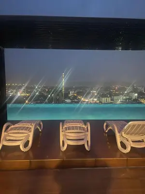 two benches in front of a window with a view at The Horizon Ipoh 3BR MAGNOLIA -by Goswell in Ipoh