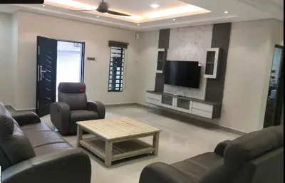 a living room with couches and a flat screen tv at Orkid Apartment Ringlet in Cameron Highlands