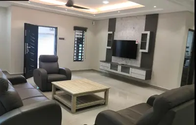 a living room with couches and a flat screen tv at Orkid Apartment Ringlet in Cameron Highlands