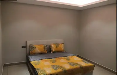 a bed in a room with two pillows on it at Orkid Apartment Ringlet in Cameron Highlands