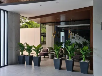 a lobby with a row of potted plants at The Cove Hillside Residence Ipoh-Nature On Earth in Ipoh