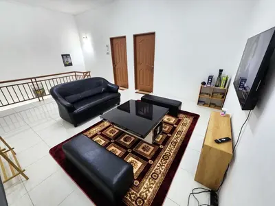 a living room with a couch and a table at Dirgahayu Homestay I Rajawali in Kulim