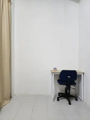 a chair sitting in front of a desk in a room at Dirgahayu Homestay I Rajawali in Kulim