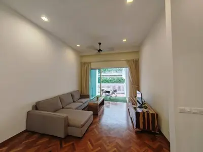 a living room with a couch and a television at Sweet Cozy Marina Suite at Straits Quay in Tanjong Tokong
