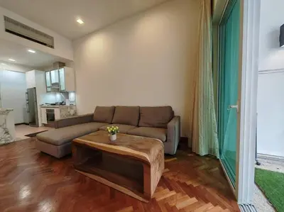 a living room with a couch and a table at Sweet Cozy Marina Suite at Straits Quay in Tanjong Tokong