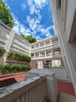 a large white building with a walkway in front of it at Sweet Cozy Marina Suite at Straits Quay in Tanjong Tokong