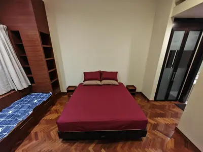 a bedroom with a bed in the middle of a room at Sweet Cozy Marina Suite at Straits Quay in Tanjong Tokong