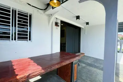 a wooden counter in a room with a wall at Bercham 81 Homestay in Ipoh