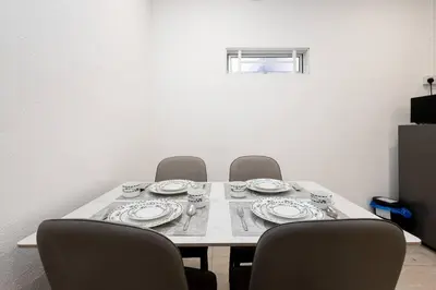 a table with chairs and plates and cups on it at Casa for 4 - Private Studio Ipoh in Ipoh