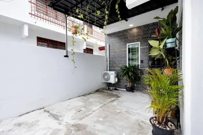 a room with potted plants and a tv on a wall at Casa for 4 - Private Studio Ipoh in Ipoh