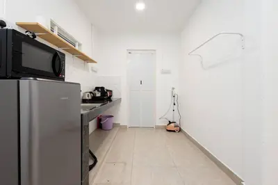a kitchen with a refrigerator and a counter top at Casa for 4 - Private Studio Ipoh in Ipoh