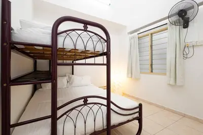 a bedroom with two bunk beds and a fan at Homie4u - Ipoh Garden East 8 pax in Ipoh