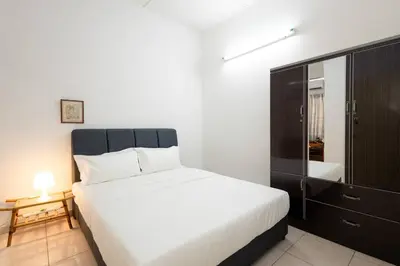 a bedroom with a large bed and a dresser at Homie4u - Ipoh Garden East 8 pax in Ipoh