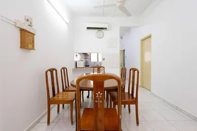 a dining room with a wooden table and chairs at Homie4u - Ipoh Garden East 8 pax in Ipoh