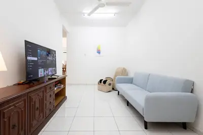 a living room with a couch and a flat screen tv at Homie4u - Ipoh Garden East 8 pax in Ipoh