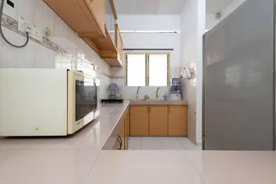 a large kitchen with a white refrigerator and a window at Homie4u - Ipoh Garden East 8 pax in Ipoh