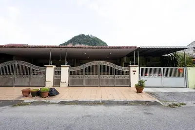 a house with a gate and some potted plants at Homie4u - Ipoh Garden East 8 pax in Ipoh