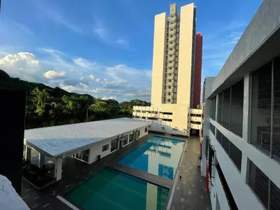 a building with a swimming pool next to a building at the Anderson Ipoh 2BR by Goswell in Ipoh