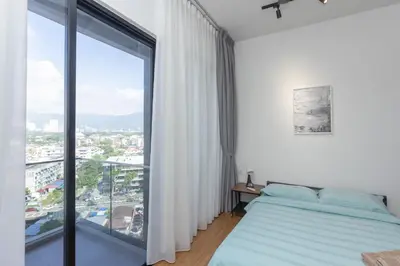 a bedroom with a bed and a large window at Beacon Executive Suite by MAY in George Town