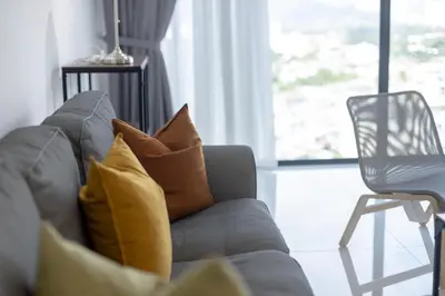 a couch with pillows and a chair in a living room at Beacon Executive Suite by MAY in George Town