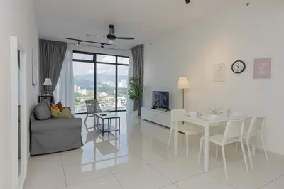 a white living room with a table and a couch at Beacon Executive Suite by MAY in George Town