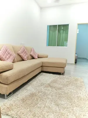 a brown couch in a living room with a rug at Penang Georgetown Jelutong Luxury House 1-12Pax in Jelutong