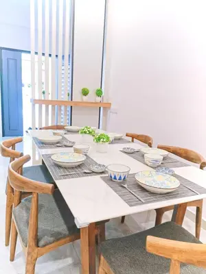 a table with plates and bowls on top of it at Penang Georgetown Jelutong Luxury House 1-12Pax in Jelutong