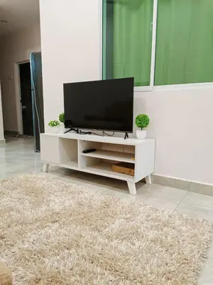 a living room with a flat screen tv on a white cabinet at Penang Georgetown Jelutong Luxury House 1-12Pax in Jelutong