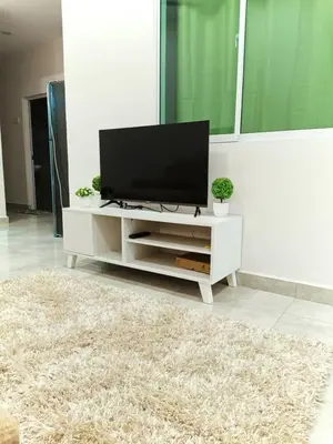 a living room with a flat screen tv on a white cabinet at Penang Georgetown Jelutong Luxury House 1-12Pax in Jelutong