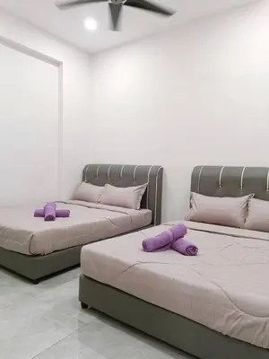 two beds in a room with purple pillows on them at Penang Georgetown Jelutong Luxury House 1-12Pax in Jelutong
