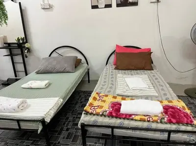 two beds sitting next to each other in a room at Near Aeon Taiping and Taiping Sentral Mall in Kamunting