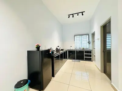 a kitchen with a black refrigerator in a room at Rania Pearl Double Storey Family Home, Bertam Penang Homestay in Kepala Batas