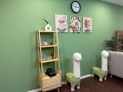 two stuffed animals are standing next to a shelf in a room at Cameron Palas Homestay in Brinchang