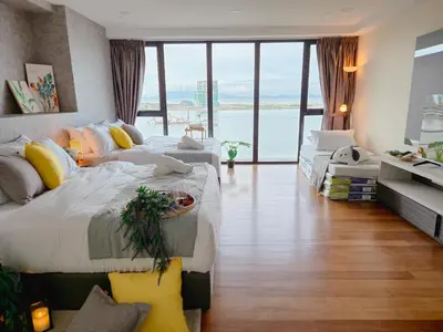 a large bedroom with two beds and a large window at NEW Sunrise Gurney with SEAVIEW \u65e0\u654c\u65e5\u51fa\u6d77\u666f in George Town