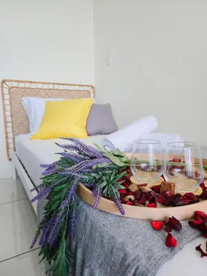 a tray of food and wine glasses on a couch at NEW Sunrise Gurney with SEAVIEW \u65e0\u654c\u65e5\u51fa\u6d77\u666f in George Town