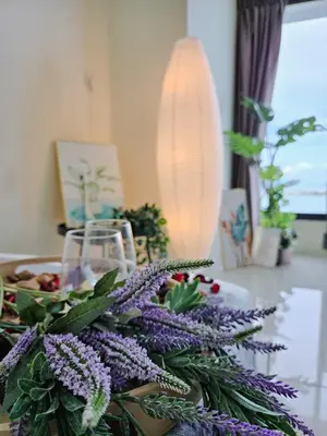 a table with a bouquet of purple flowers on it at NEW Sunrise Gurney with SEAVIEW \u65e0\u654c\u65e5\u51fa\u6d77\u666f in George Town