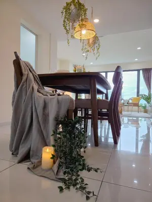 a dining room with a table and a candle on the floor at NEW Sunrise Gurney with SEAVIEW \u65e0\u654c\u65e5\u51fa\u6d77\u666f in George Town