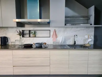 a kitchen with white cabinets and a sink at NEW Sunrise Gurney with SEAVIEW \u65e0\u654c\u65e5\u51fa\u6d77\u666f in George Town