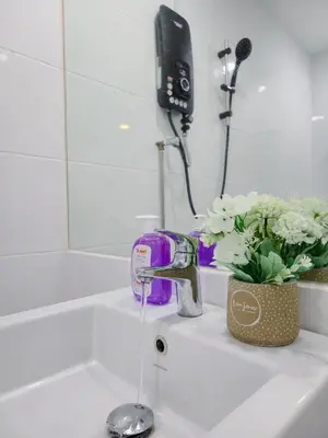 a sink with water running from a faucet at NEW Sunrise Gurney with SEAVIEW \u65e0\u654c\u65e5\u51fa\u6d77\u666f in George Town