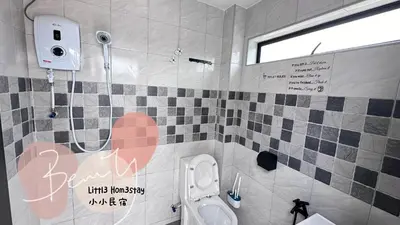 a bathroom with a toilet with writing on the wall at Little Homestay - \u5c0f\u5c0f\u6c11\u5bbf in Ipoh