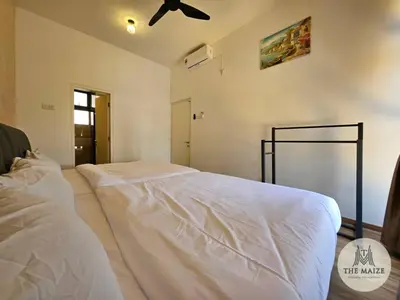 a white bed in a room with a ceiling fan at The Cove Hillside Residence Ipoh - Nostalgic Terracotta in Ipoh